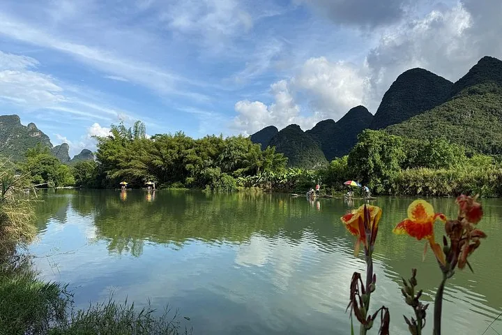 Tranquil scene of bamboo rafts on the Li River with flowers foreground